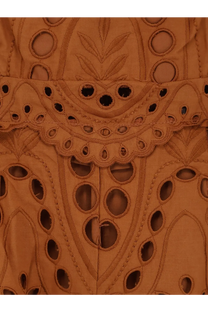 Tan eyelet lace fabric with intricate floral and geometric cut-out patterns on charo ruiz ibiza womens glimmer long dress brown