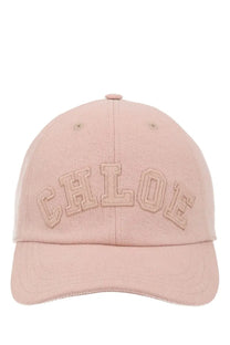 A soft pink chloé women’s baseball cap with embroidered chloe logo in matching tone on the front