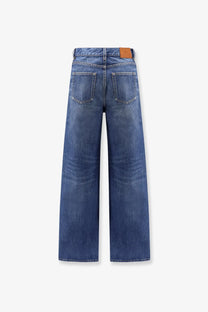 Chloé women’s blue denim jeans with wide-leg cut and brown leather patch at the waistband back view