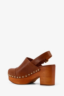 Brown leather clog sandal with chunky wooden heel and gold tone studs along the toe by chloé