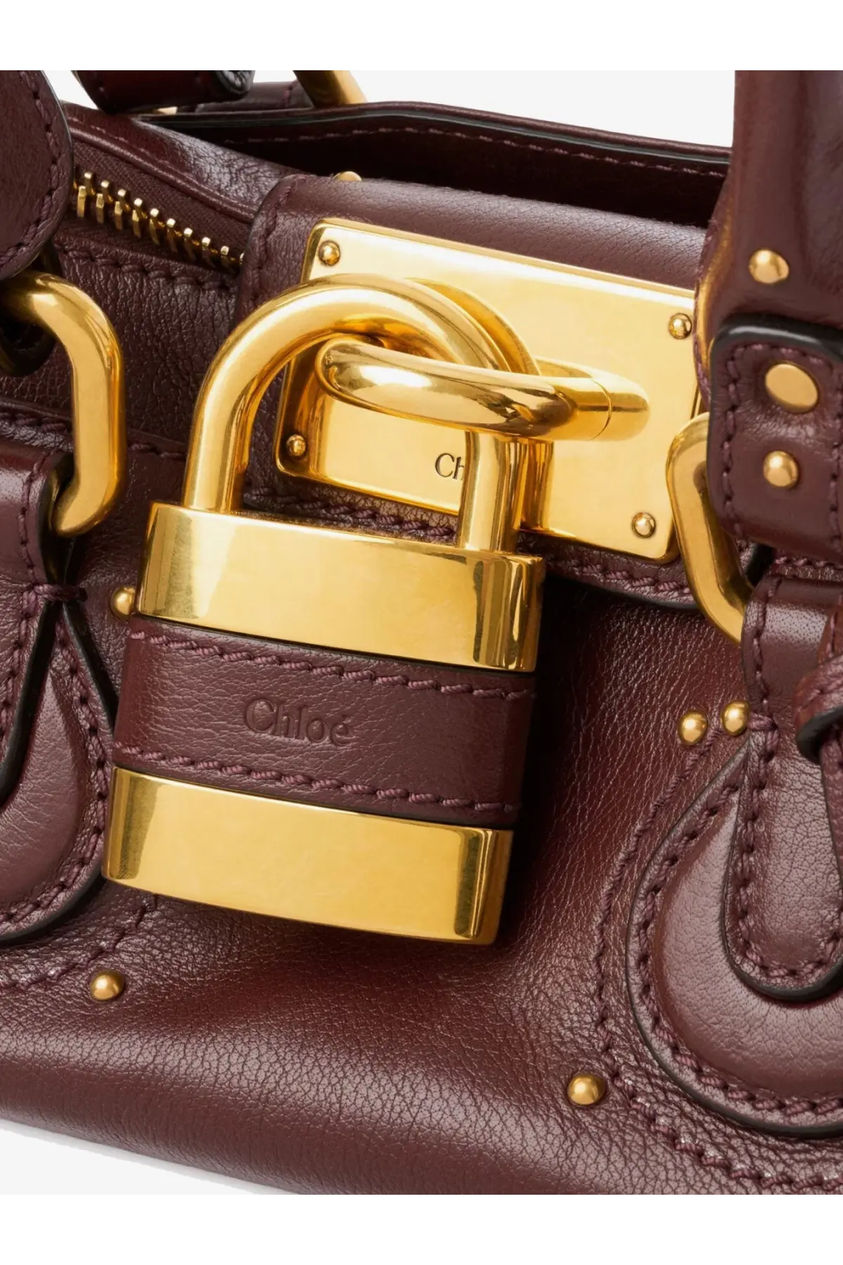 A burgundy leather chloé women’s shoulder bag with gold-tone padlock closure and embossed brand name on strap