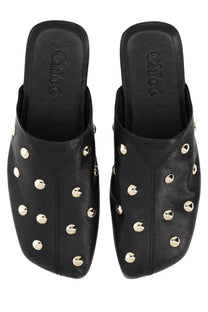 Black leather Chloé women’s Sabot Rita mules adorned with gold-tone studs showcasing stylish luxury design