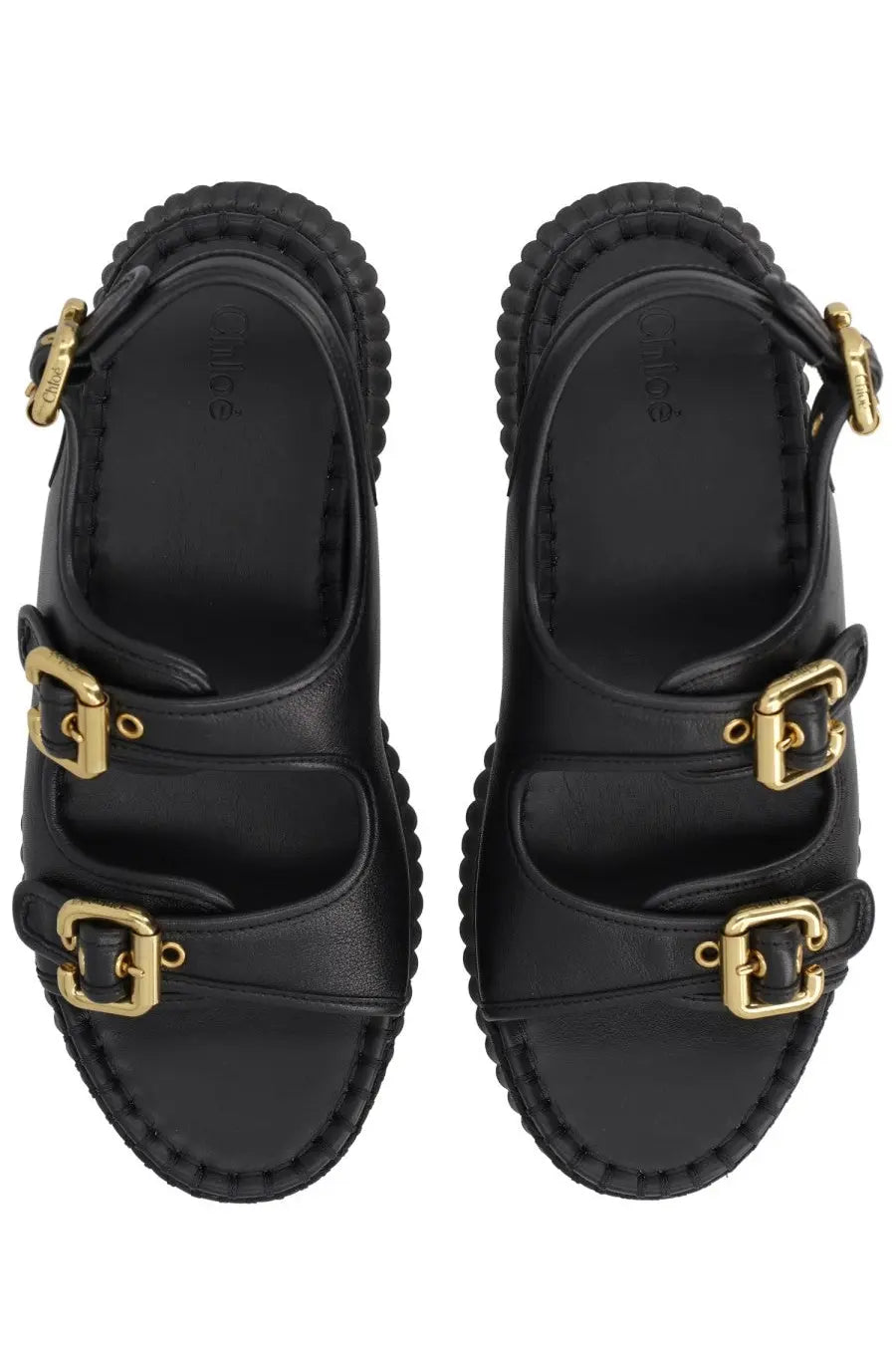 Chloé women’s black leather sandals with gold-tone buckle straps and a textured chunky sole