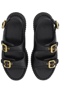 Chloé women’s black leather sandals with gold-tone buckle straps and a textured chunky sole