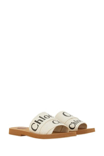Chloé women’s sandal woody white cream canvas slides with black logo straps and tan rubber sole for casual wear