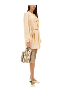 Beige canvas tote bag with black chloé lettering on handles and gold tone chain detail for women