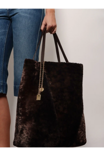 A plush dark brown velvet tote bag with long handles and gold chain charm from chloé women’s spin shearling shoulder bag brown