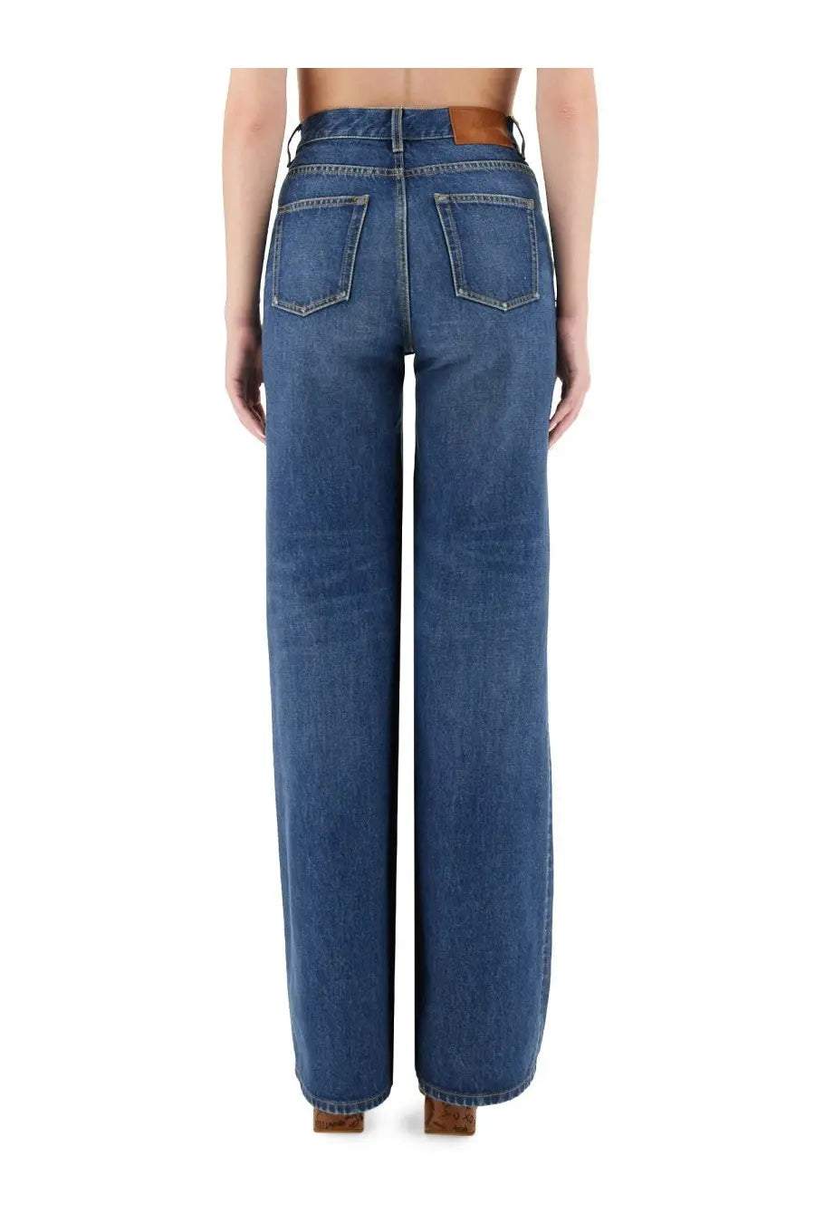 Chloé women’s wide leg blue denim jeans with a brown leather belt loop visible on the front side