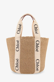 Beige woven straw tote bag with cream fabric handles and black chloé branding for women by chloé