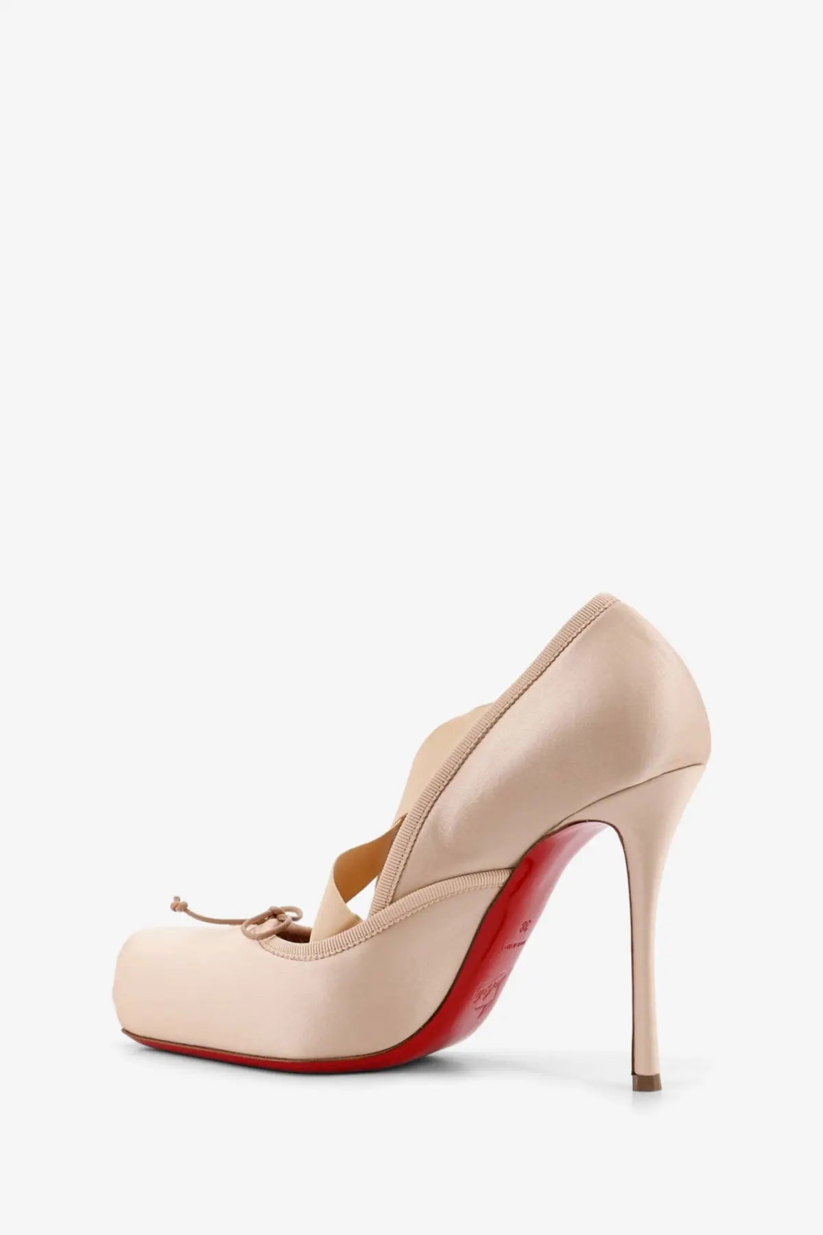 Beige patent leather christian louboutin pump with red sole and thin high heel shown from the back side