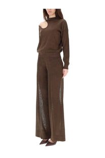 Brown knit set with high neck and cut-out shoulder paired with circus hotel women’s tailored brown pants with sheer mesh panels