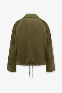 Olive green utility jacket with a drawstring hem and raglan sleeves.