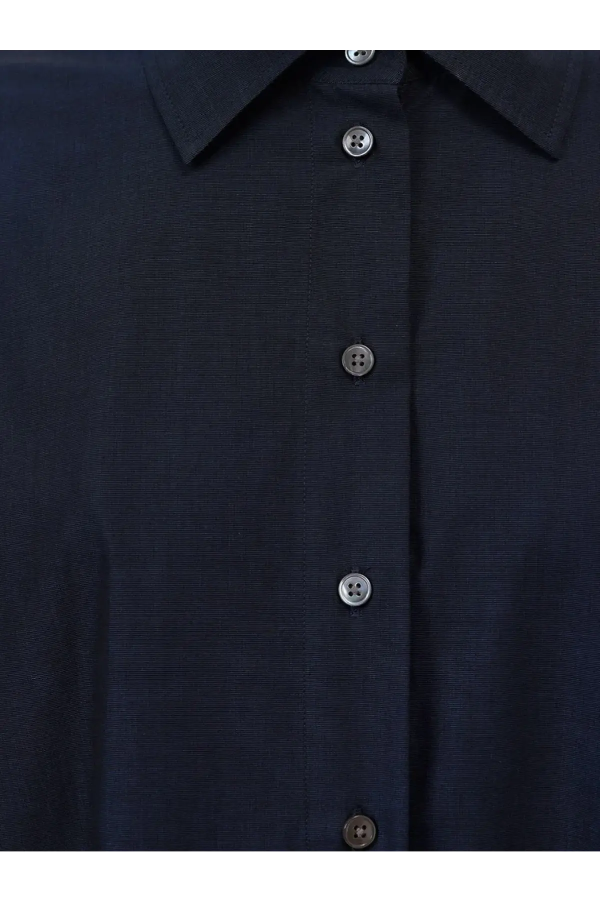 Dark navy blue closed women’s cotton shirt with subtle textured fabric and matching metallic buttons