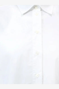 White closed women’s cotton button-down shirt with a crisp collar and matching buttons
