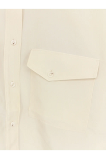 Cream-colored closed women’s cropped silk shirt with flap pocket and matching buttons in white color