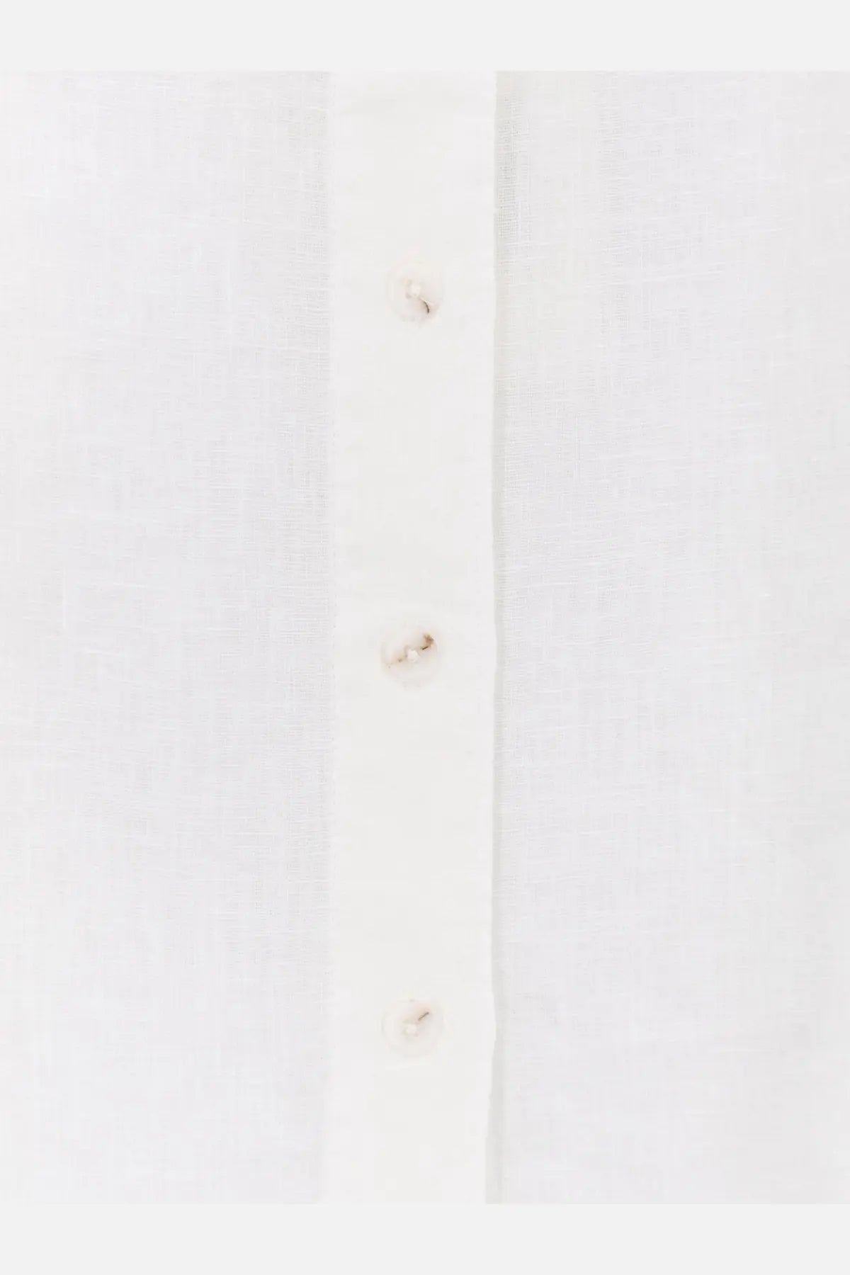White women’s linen shirt by closed with subtle texture and matching buttons in a classic button-down style