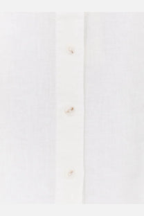 White women’s linen shirt by closed with subtle texture and matching buttons in a classic button-down style
