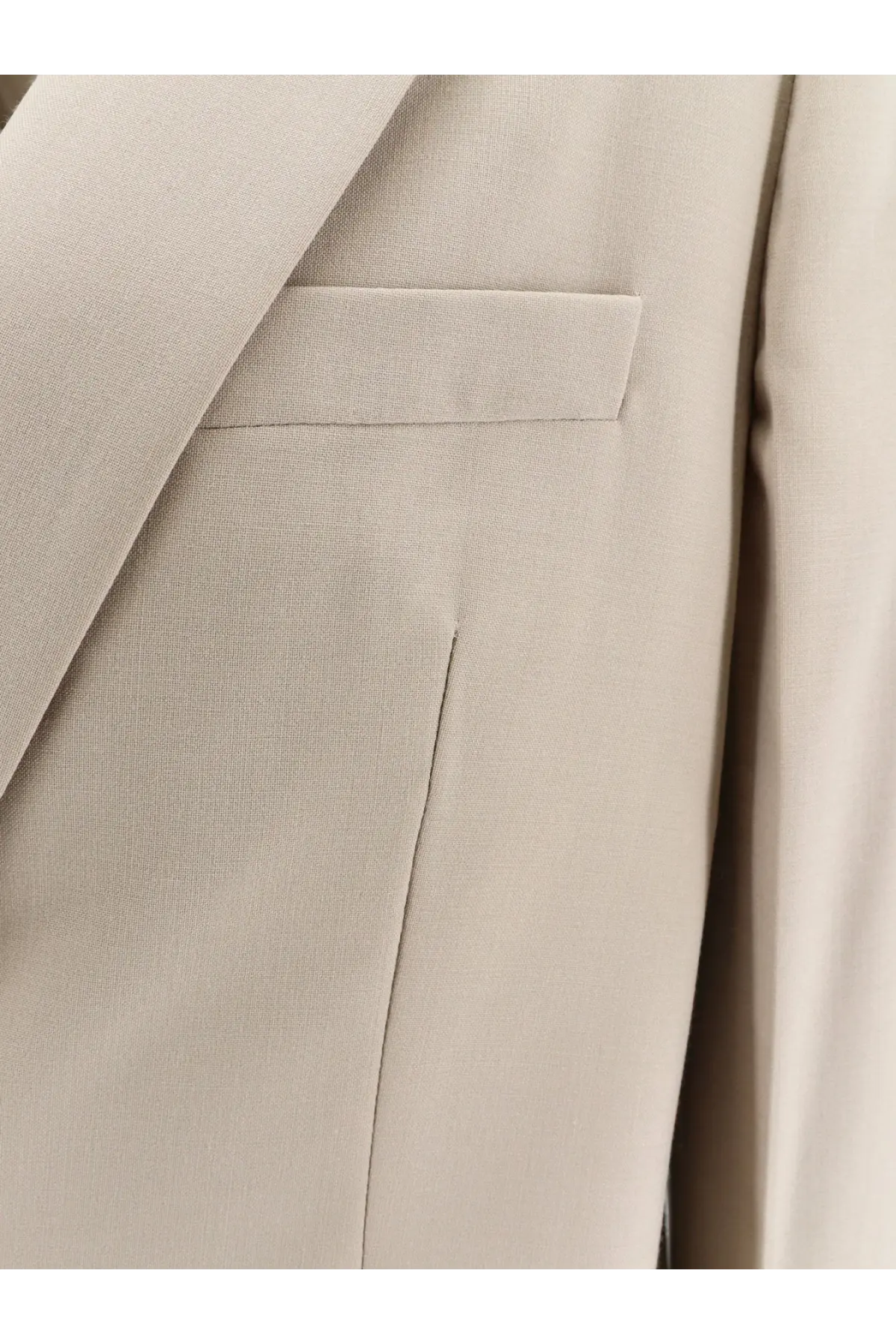 Beige textured closed women’s virgin wool blend blazer with structured lapel and subtle stitching details
