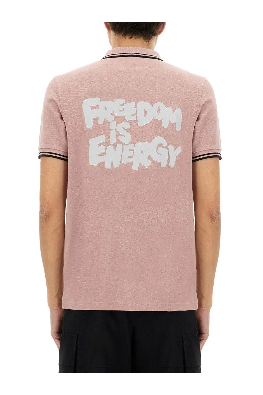 Comme des garcons shirt men’s dusty rose polo with black trim and white graffiti style freedom is energy graphic on back