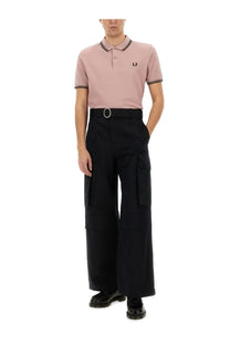 Comme des garcons shirt men’s polo freedom blue in pink with black trim and fred perry embroidered logo on chest
