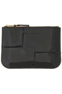 Black glossy patent leather clutch with gold-tone zipper and stitched seams from Comme Des Garcons unisex reversed hem wallet series