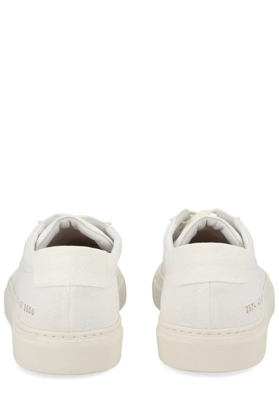 Common projects men’s sneaker achilles white showing the back side of white canvas sneakers with subtle heel branding
