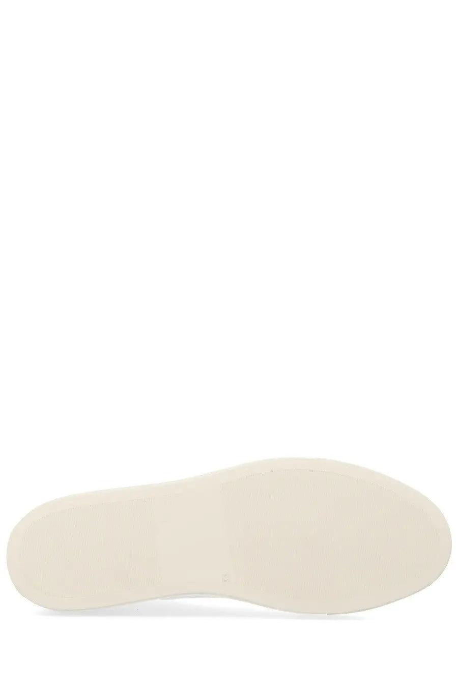 Cream-colored rubber sole of common projects men’s sneaker achilles white with smooth minimalist design