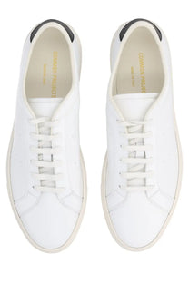 Common projects men’s sneaker achilles white leather with black heel tabs and cream soles in minimalist design