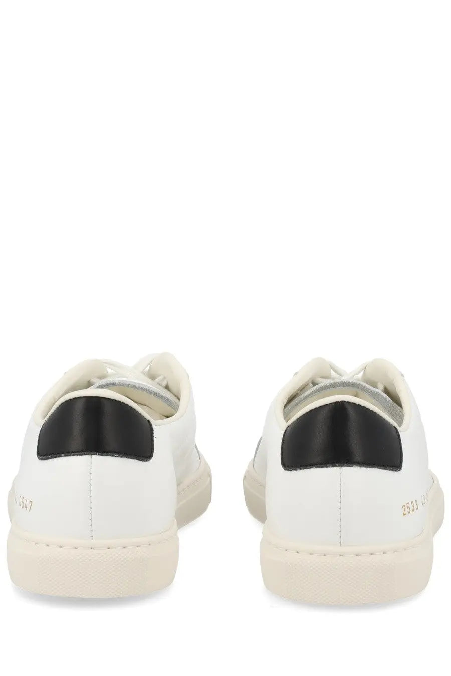 Common projects men’s sneaker achilles white leather sneakers with black rubber heel tabs and beige soles back view