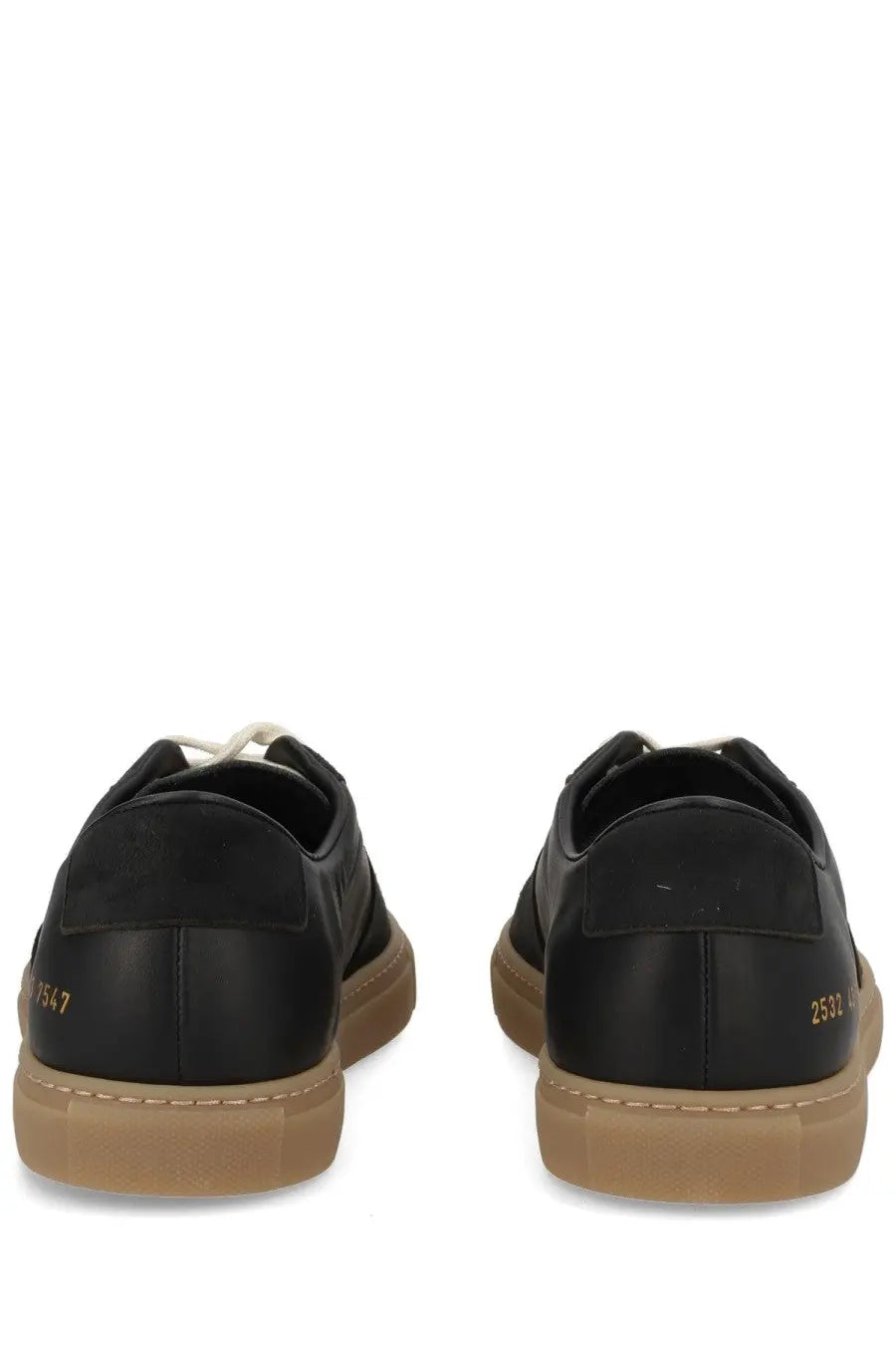 Common projects men’s sneaker bball black black leather with tan rubber soles and gold branding on the heel back view