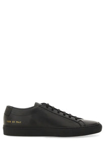Common projects men’s low achilles original black leather sneaker showing back with gold numerical heel detail