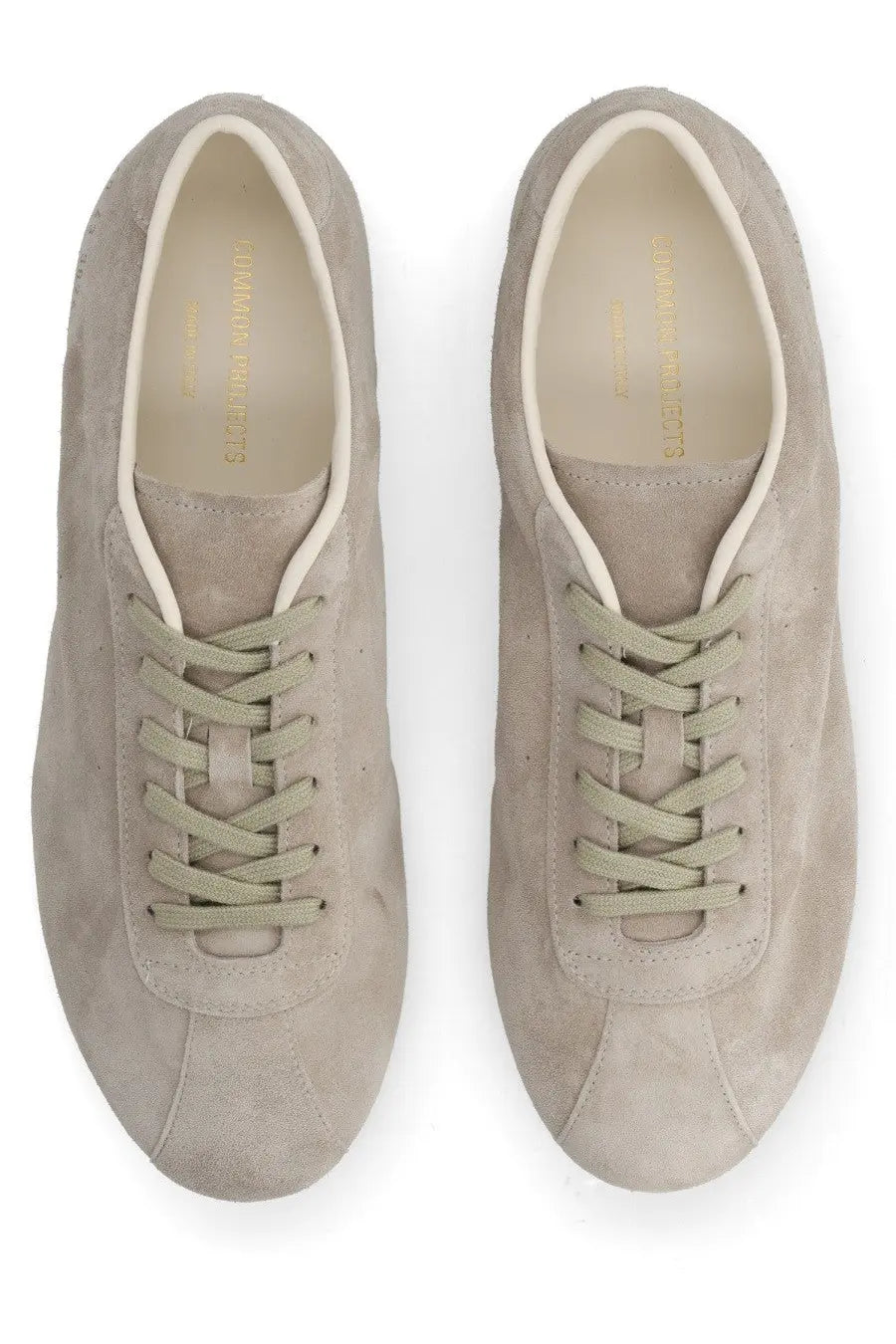 Common projects men’s sneaker in suede beige with matching laces and minimalist design front view