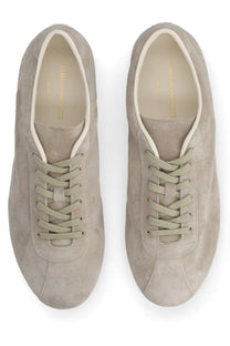 Common projects men’s sneaker in suede beige with matching laces and minimalist design front view