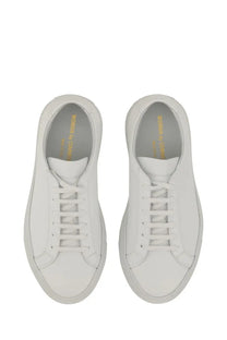 Common Projects women’s low original Achilles white leather low-top sneakers with minimalist design and gold branding inside heel