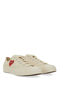 Converse men’s chuck taylor cream canvas sneakers with bold red heart and black eyes by comme des garçons
