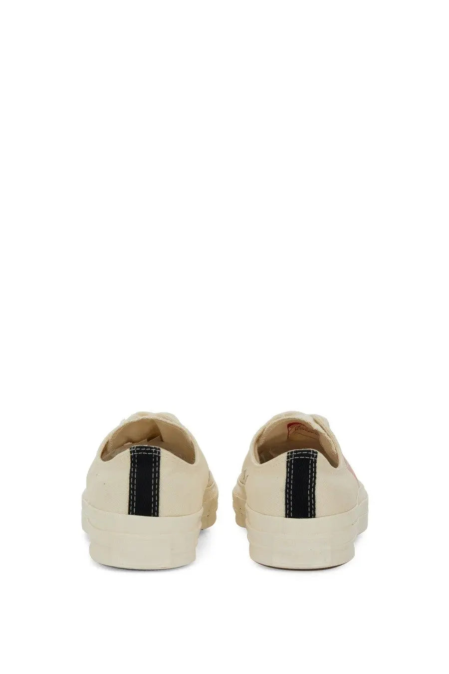 Cream-colored canvas converse men’s chuck taylor sneaker with black vertical stripe on the back heel and white stitching details