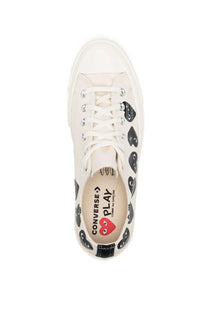 Off-white canvas converse unisex chuck multi hearts sneaker with black heart faces silver eyelets and red heart logo insole