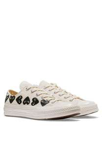 Cream-colored converse unisex chuck multi hearts sneaker white with black heart-shaped eyes decals on the side