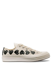 Cream-colored canvas low-top converse unisex chuck multi hearts sneaker with black heart-shaped eyes by comme des garçons