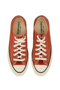 Red canvas Converse unisex Chuck OX sneaker with white laces and rubber toe cap for casual wear
