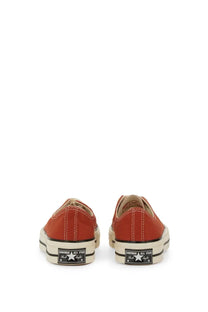 Red Converse unisex Chuck OX low-top sneakers with white rubber soles and black star logo patches