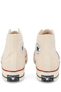 Converse unisex chuck sneaker beige cream canvas high tops with red rubber soles and black star logo patches
