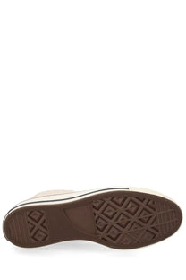 Cream-colored converse unisex chuck sneaker with brown rubber sole and black stripe featuring diamond-patterned tread
