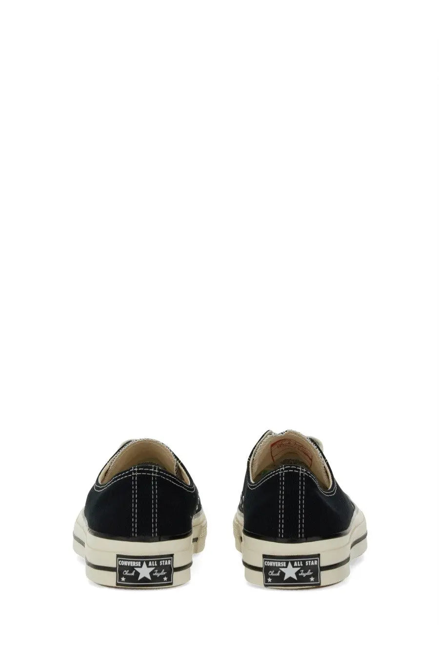 Black canvas converse unisex chuck sneaker low-top showing back side with white rubber sole and classic star logo on heel