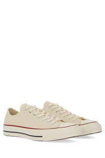 Converse unisex chuck sneaker white cream canvas low-top with red and black rubber sole stripe classic design