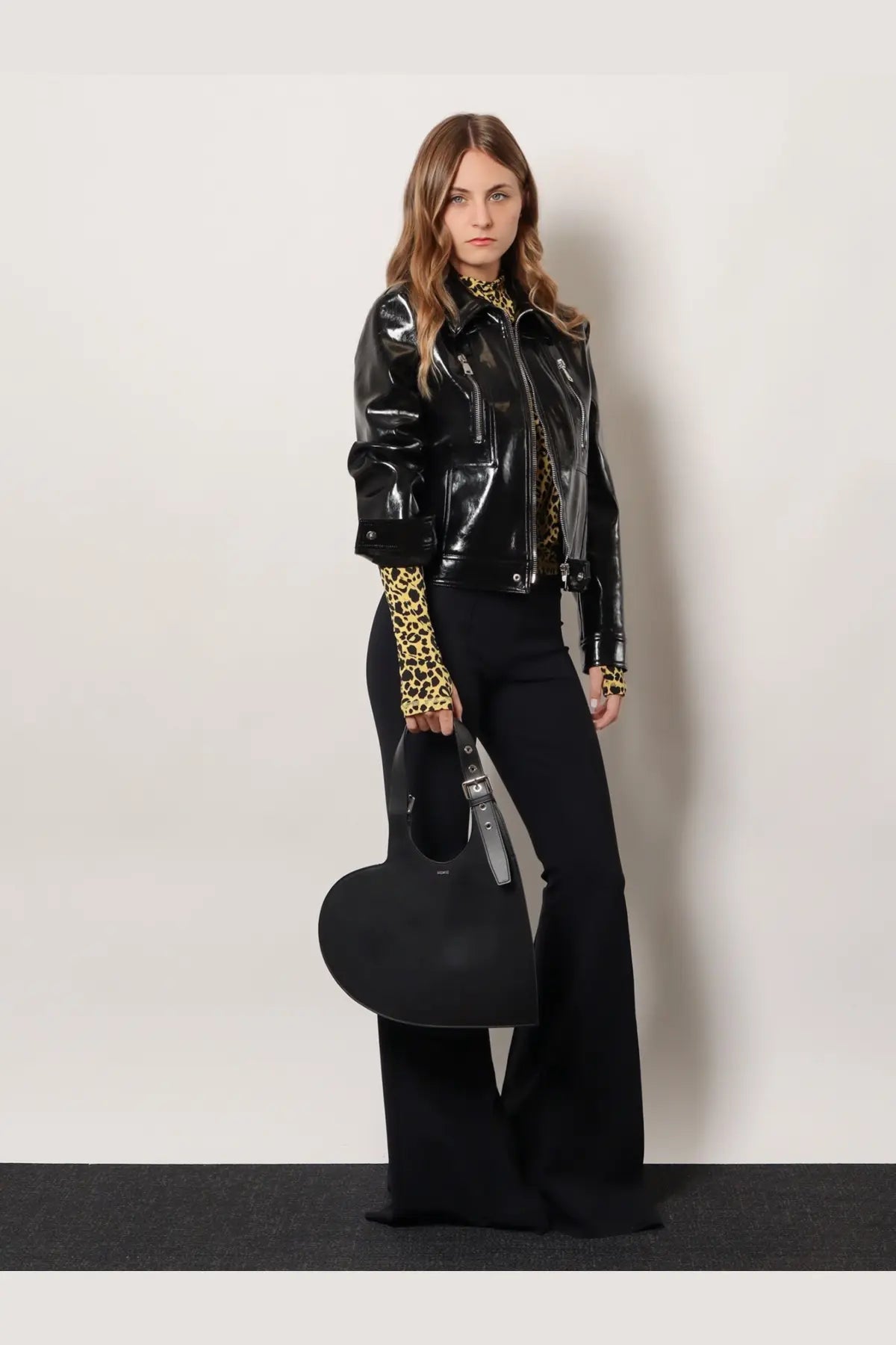Black heart-shaped handbag with silver-toned buckle and handle paired with coperni women’s knitted second skin viscose top