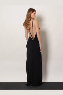 Black satin evening gown by coperni with a plunging back and thin straps shown from the back side