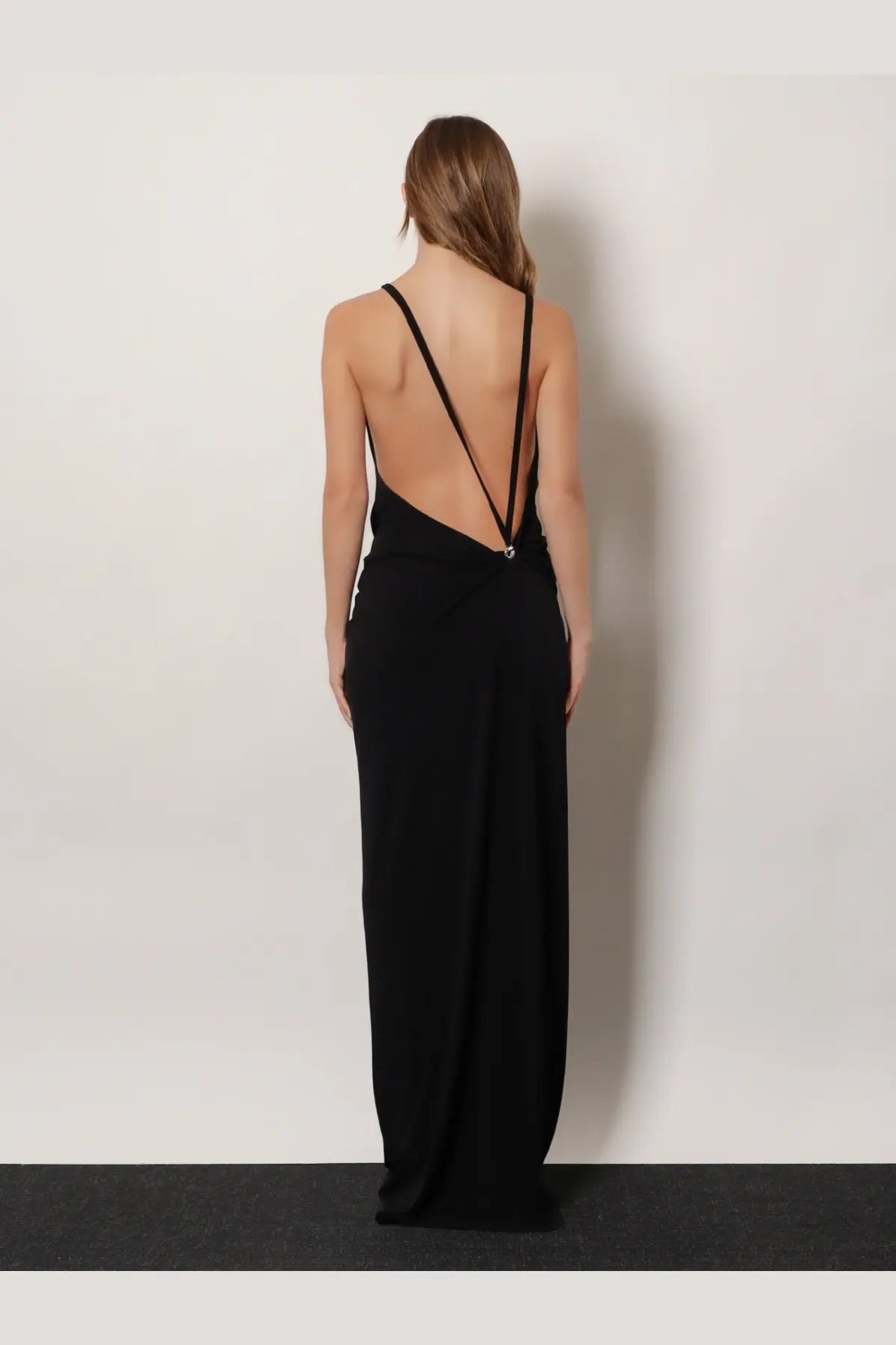 Back view of coperni women’s black stretch fabric maxi dress with spaghetti straps and deep back cutout