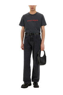 Black leather handbag with circular top handle featured alongside courrèges men’s black shirt product image