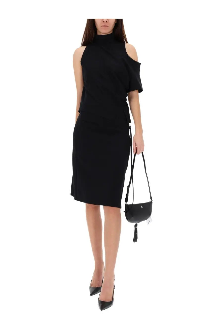 Black leather mini crossbody bag with tassel detail paired with courrèges women’s asymmetrical black shirt